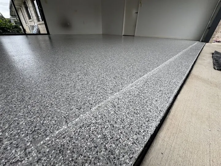 Close-up of a finished grey epoxy flake floor in a garage