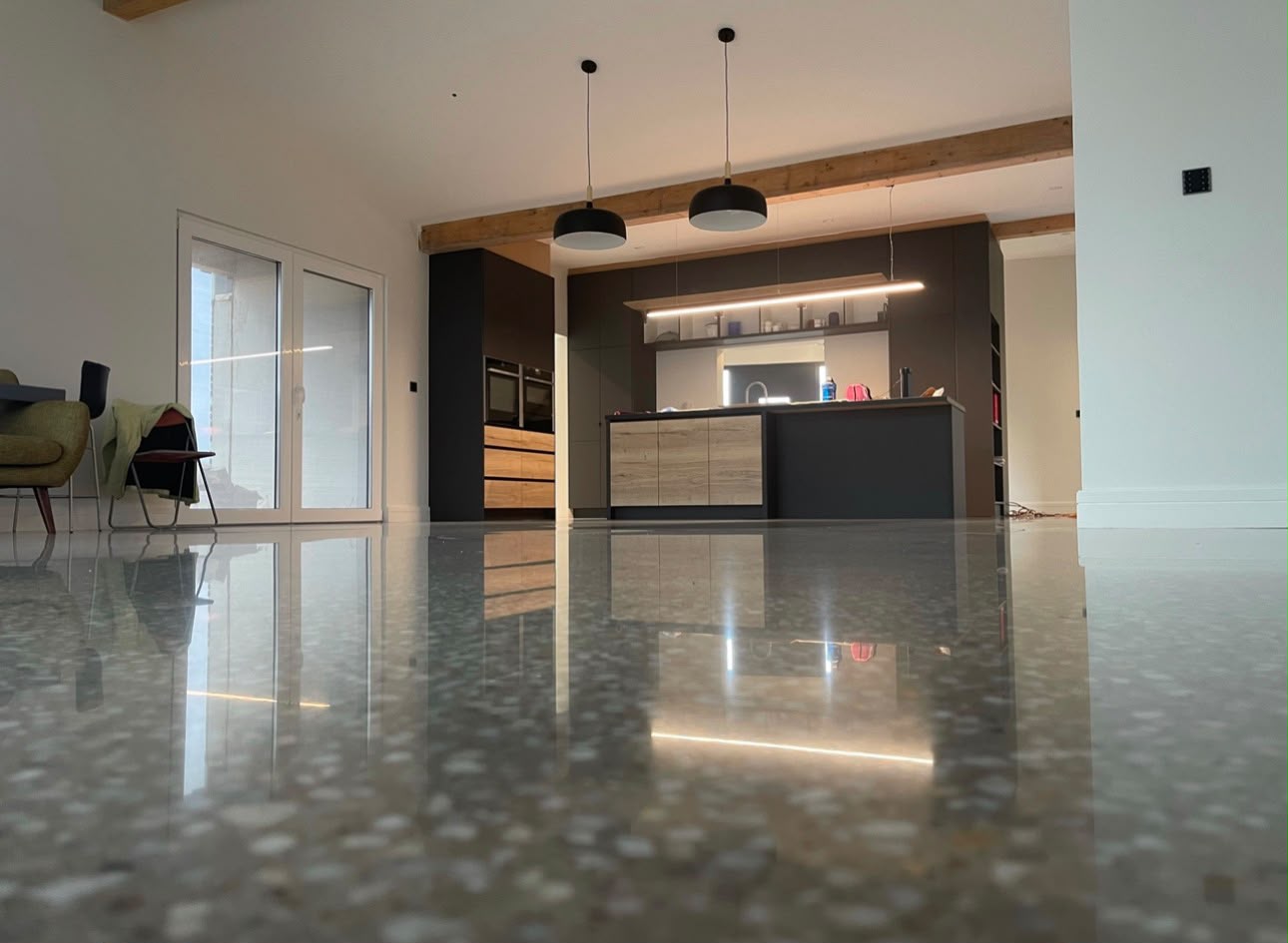 Polished concrete floor in a modern open-plan kitchen and dining space
