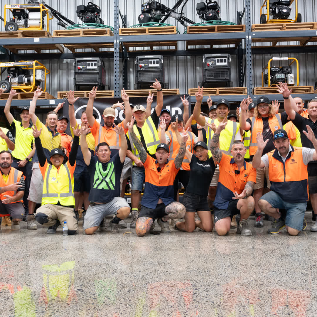Course group celebrating in front of the Rock Up Group equipment warehouse