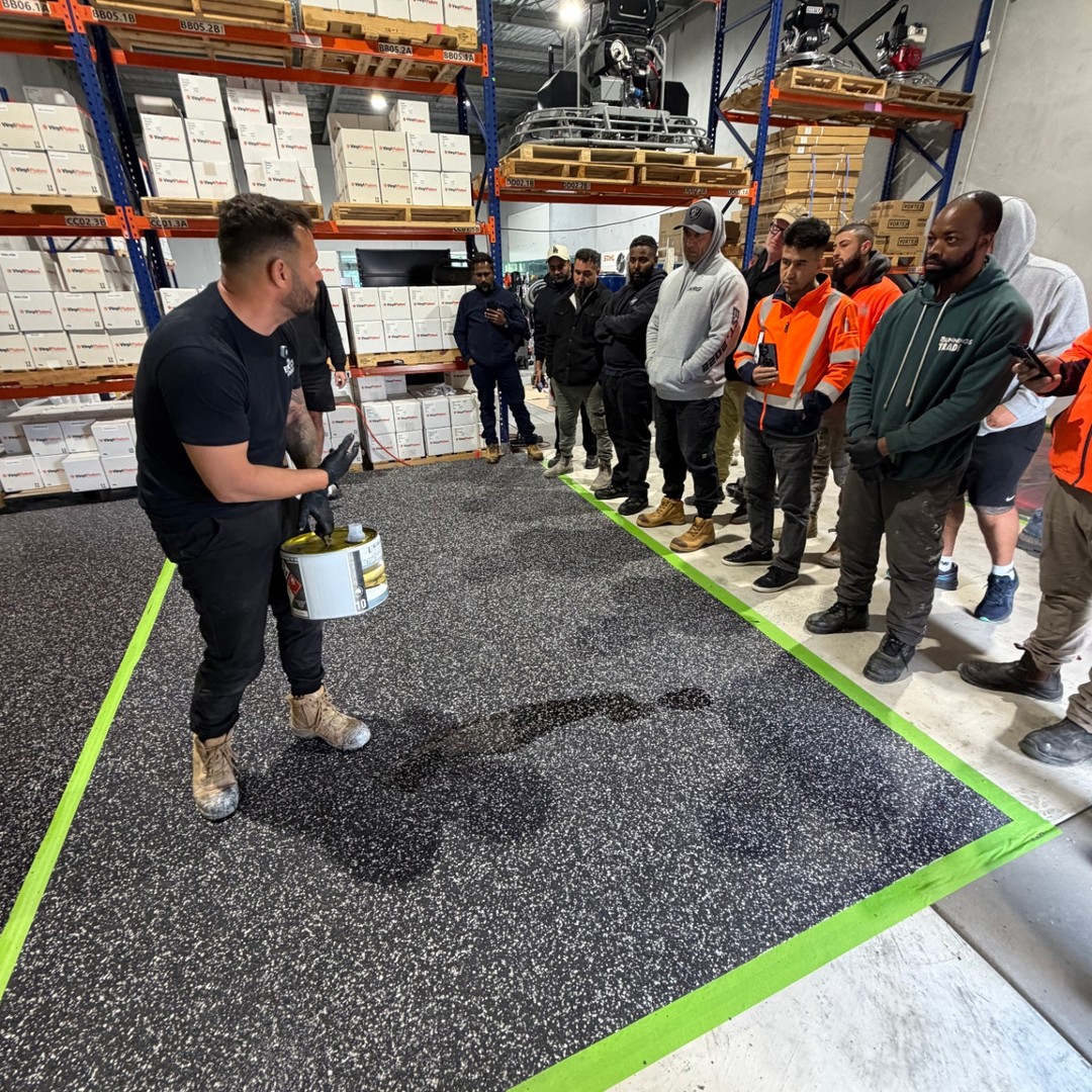 Trainer demonstrating epoxy flake application to a group of course participants